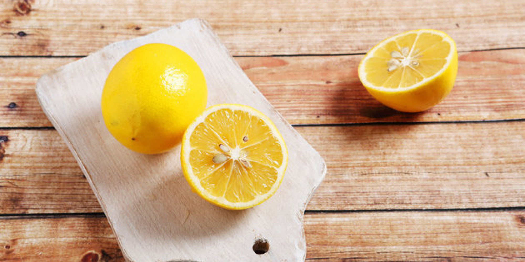 Yellow lemon on cutting board
